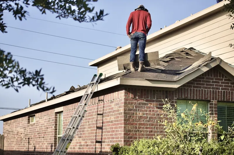 Professional roofer working on a residential roof in Village of Rose Tree